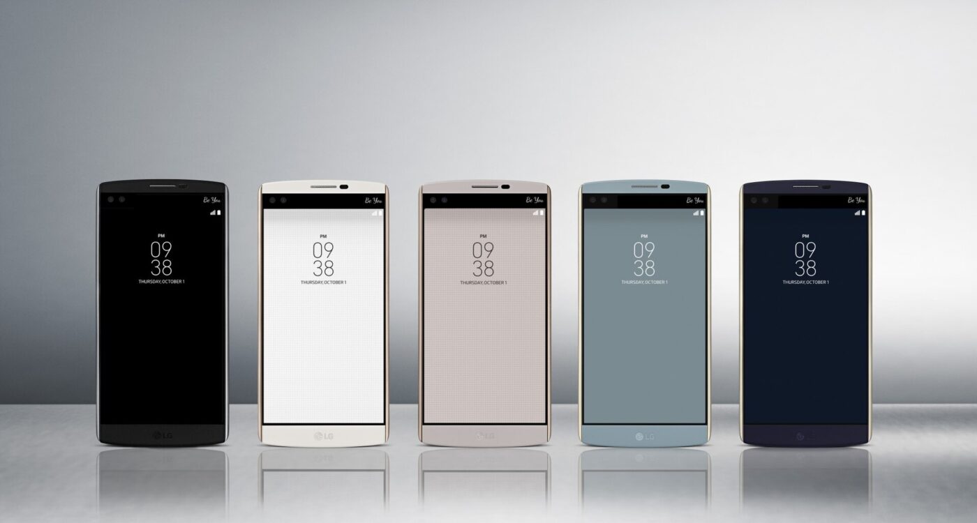 Five smartphones in different colors standing side by side.