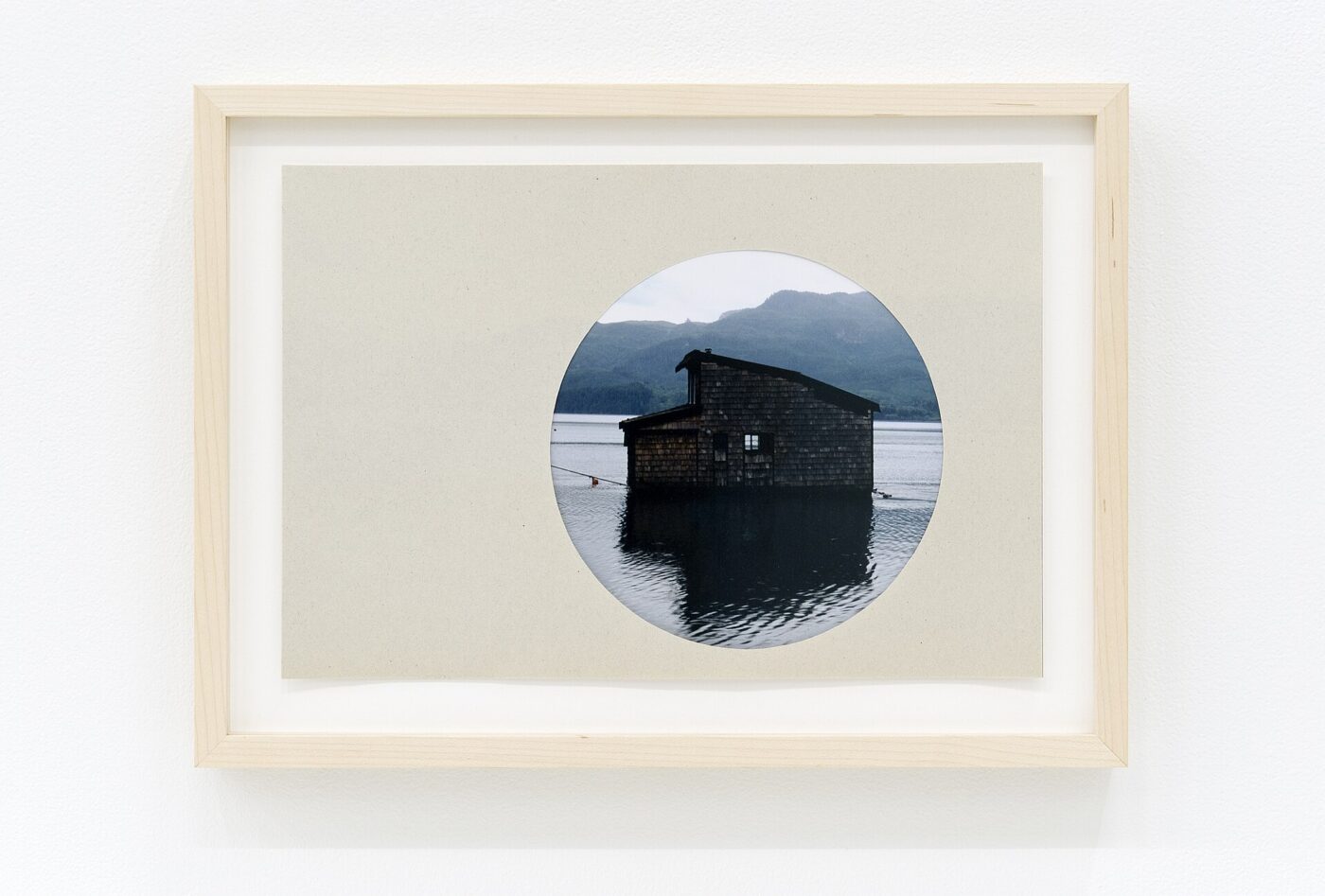A framed photographic print on a white wall.