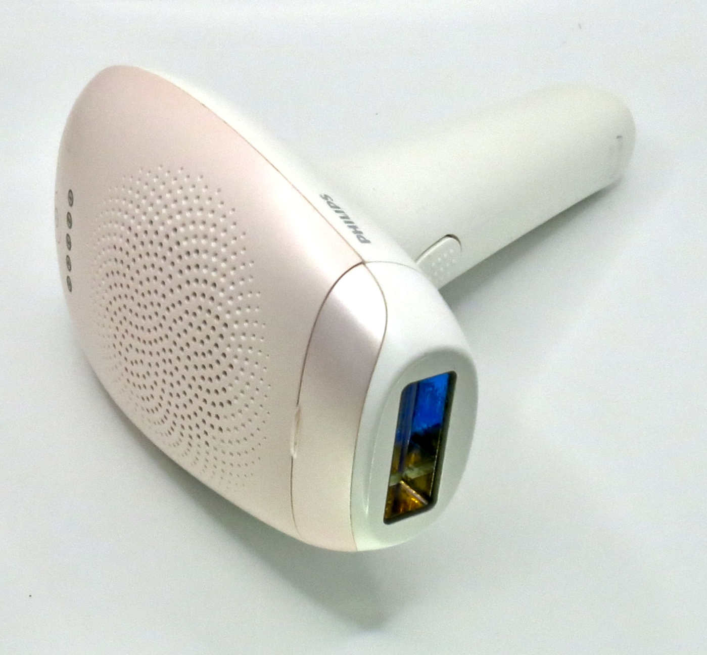 A white and gold handheld IPL hair-removal device on a plain background.