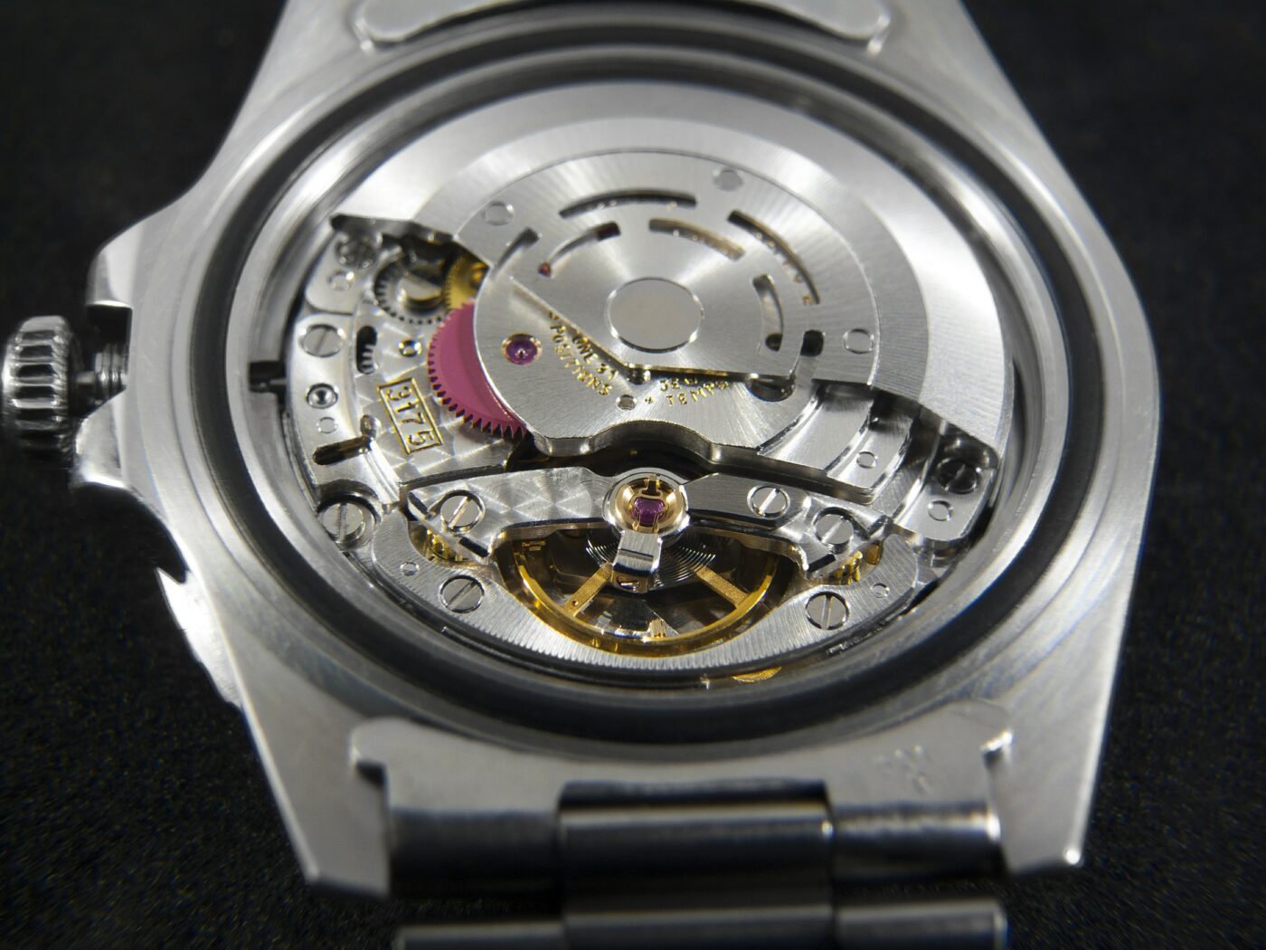 A mechanical watch movement seen through the case back.