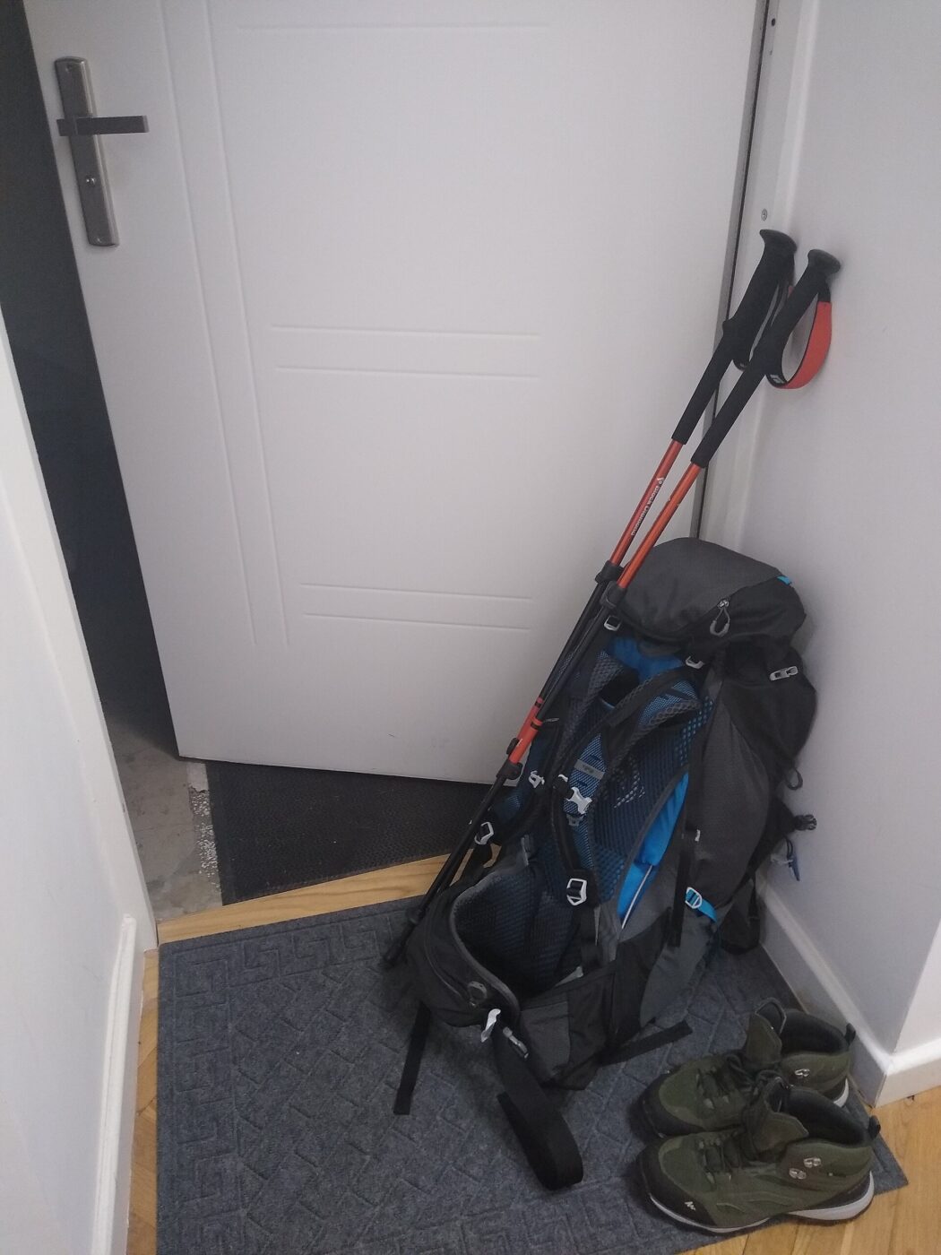 A backpack with trekking poles.
