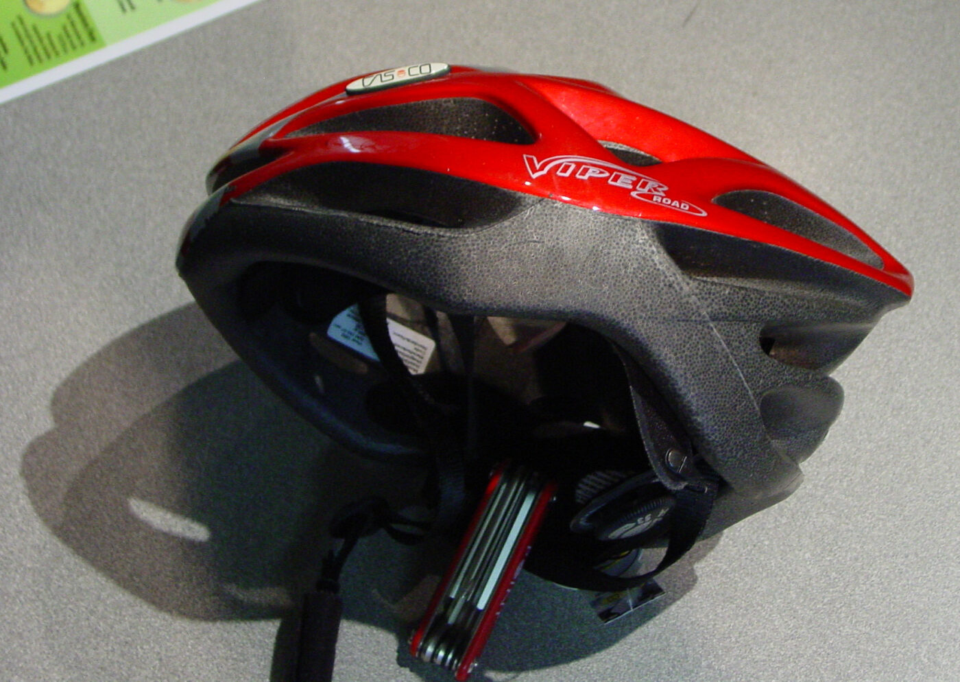 A bicycle helmet lying on its side, showing the foam liner inside the shell.