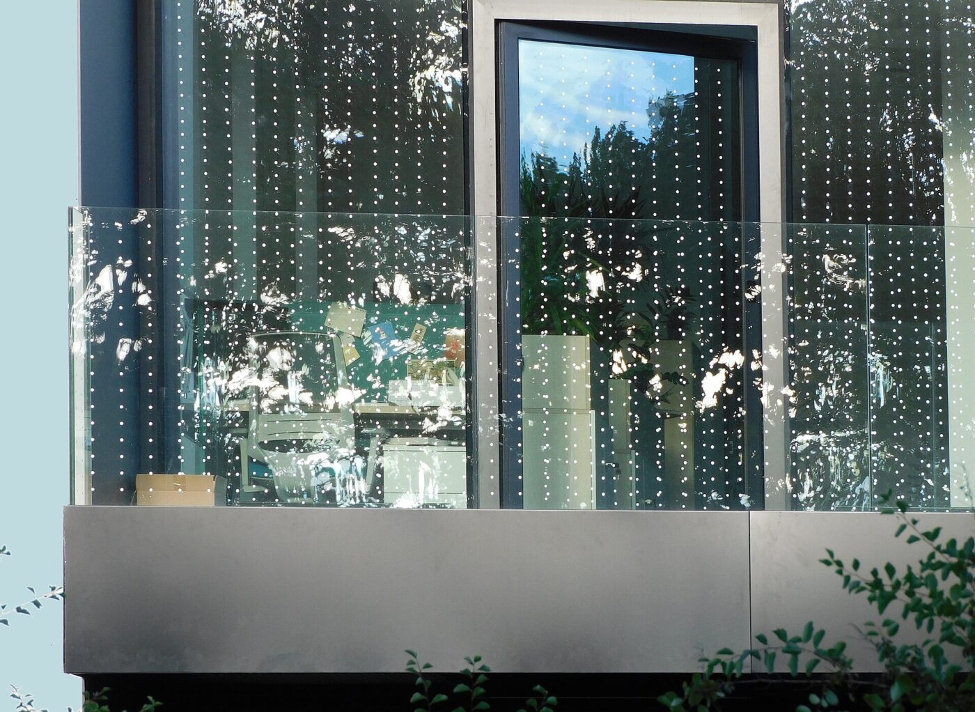 Building window covered in a dense dot pattern film to prevent bird strikes.