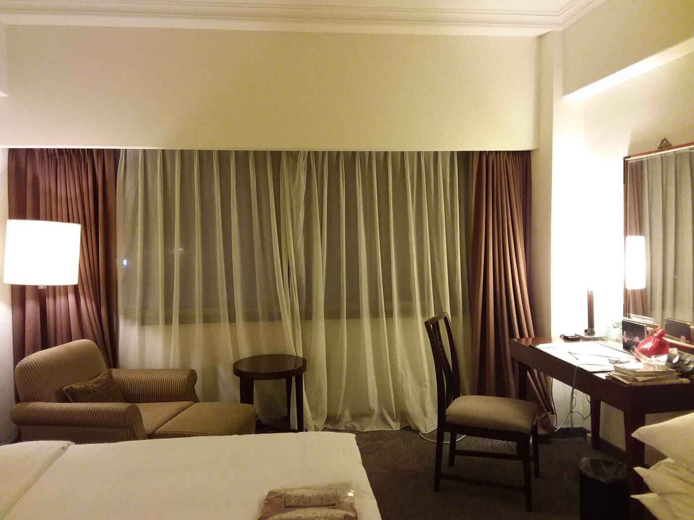 Curtains in a Taipei hotel room at night.