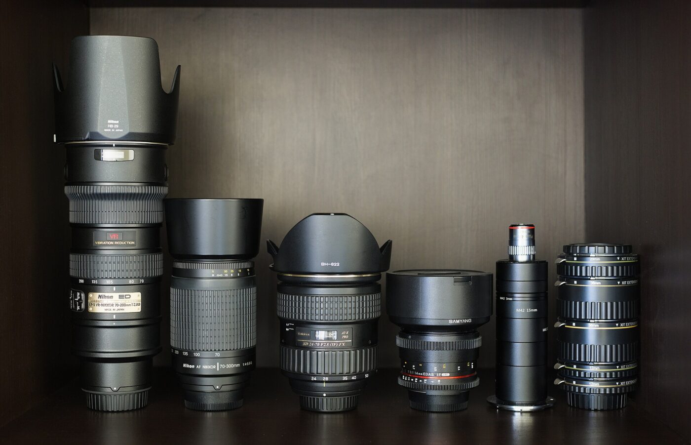 A collection of photographic lenses and extension tubes.