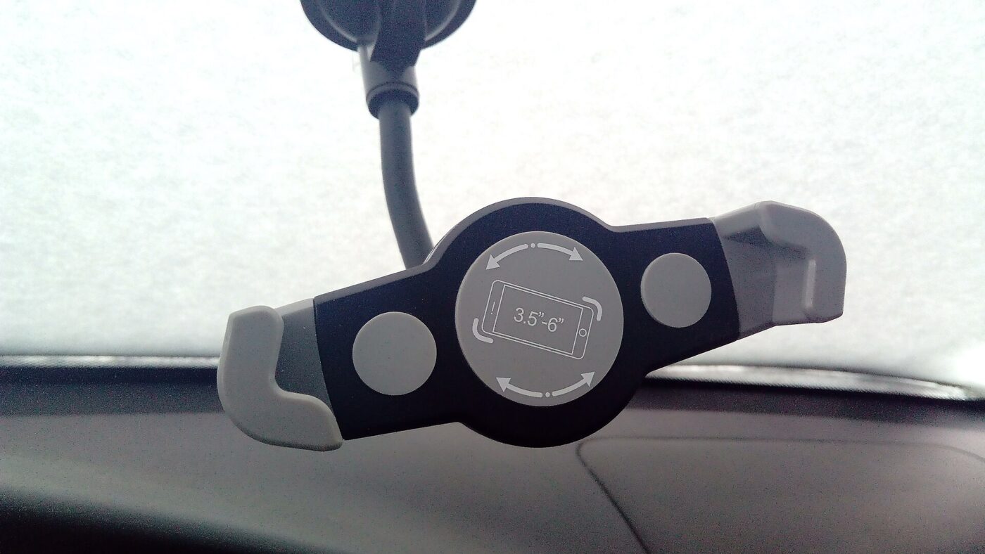 A suction-cup phone holder on a windscreen.