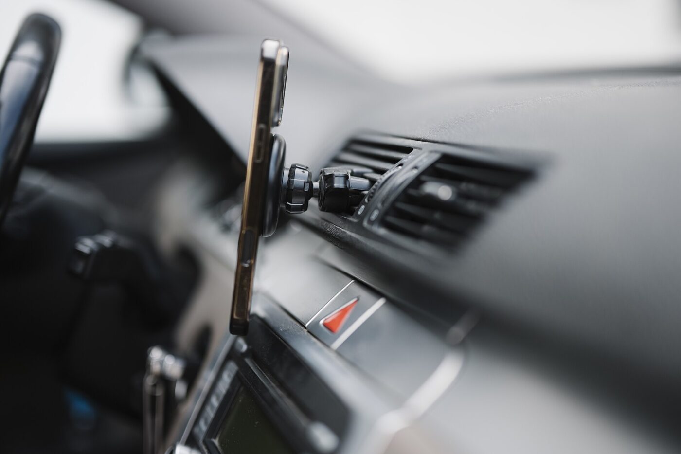 A smartphone mounted on the dashboard for navigation.