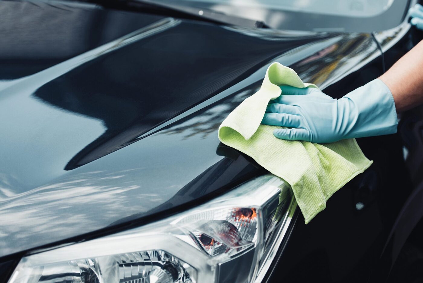 Hand-finishing paintwork at an auto detailing shop in Portland.