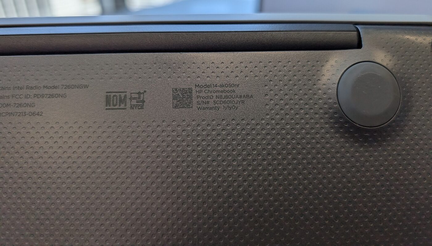 A close-up of the model and regulatory sticker on a laptop's underside.