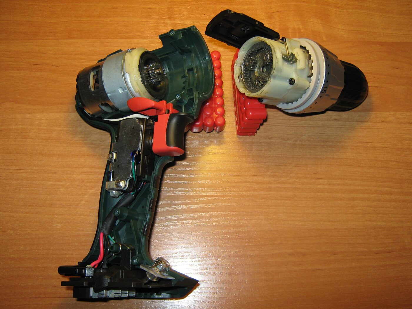 A cordless drill opened up, showing the motor and gearbox inside the housing