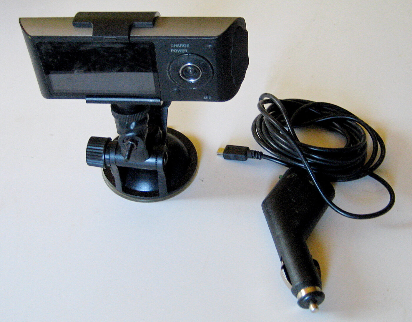 A dual-lens dashcam with its suction mount and power cable.