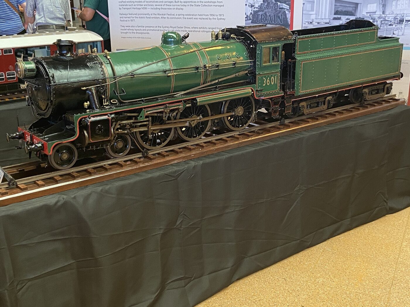 A model steam locomotive with tender on display track.