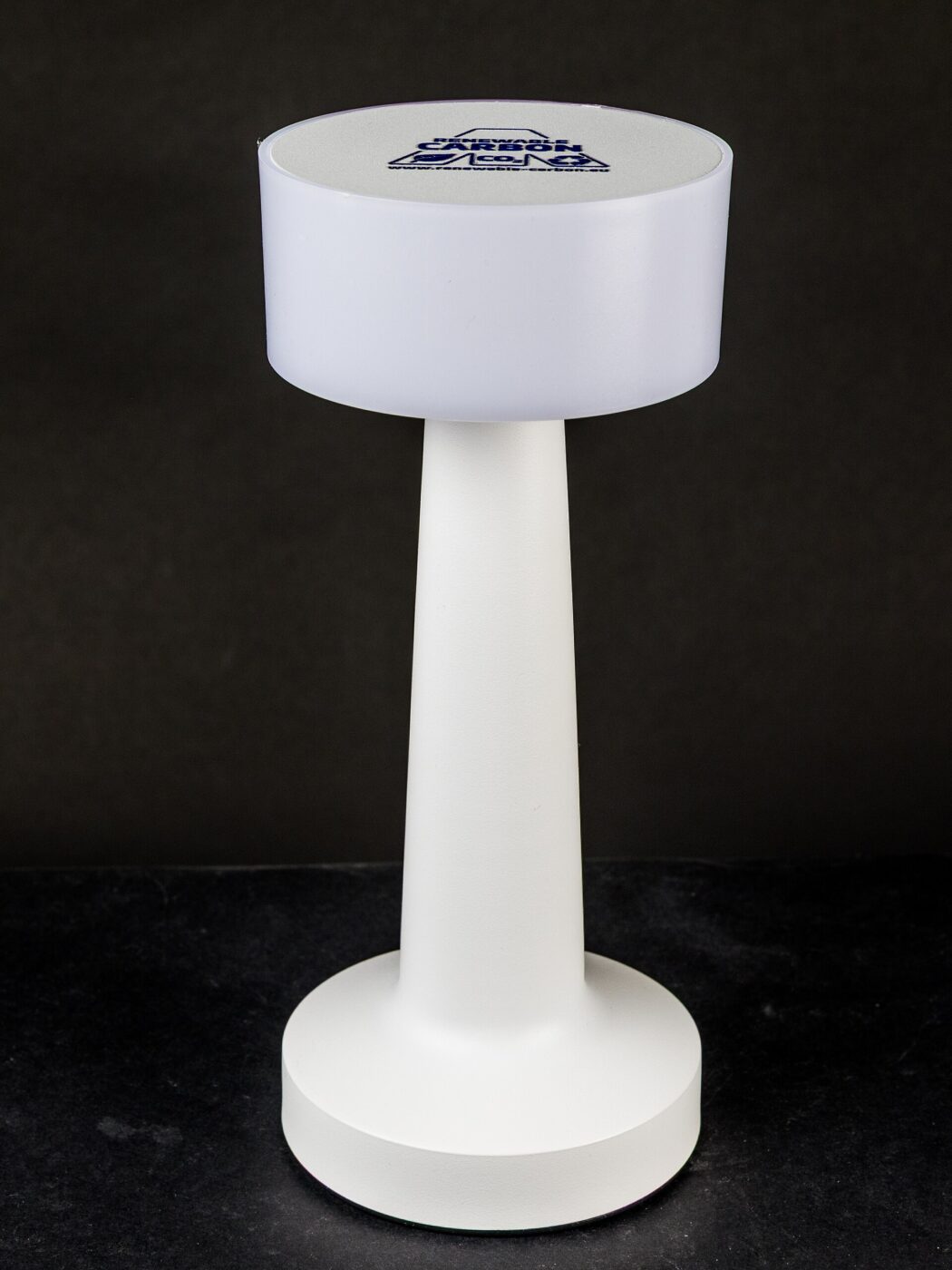 A simple white cylindrical LED desk lamp.