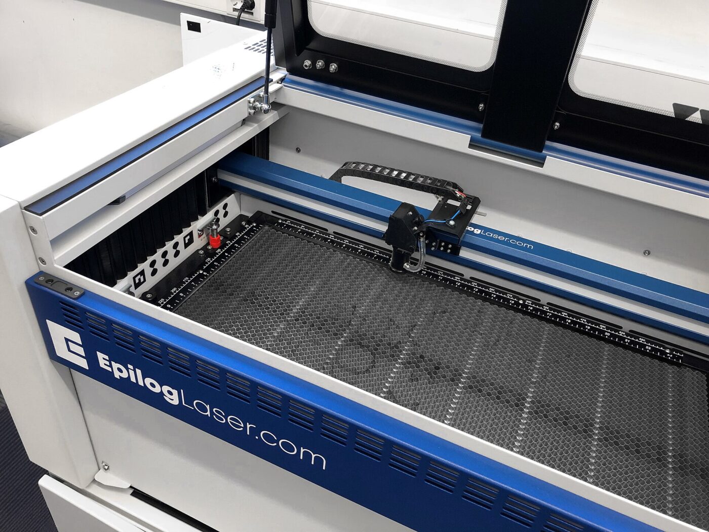 An Epilog laser engraver with its lid open.
