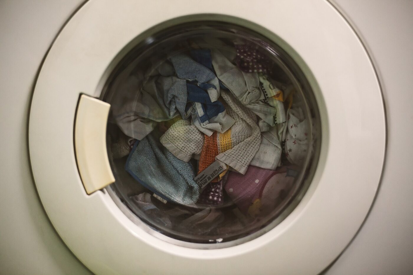 Laundry inside a front-load drum, with the door seal at the edge of the opening.