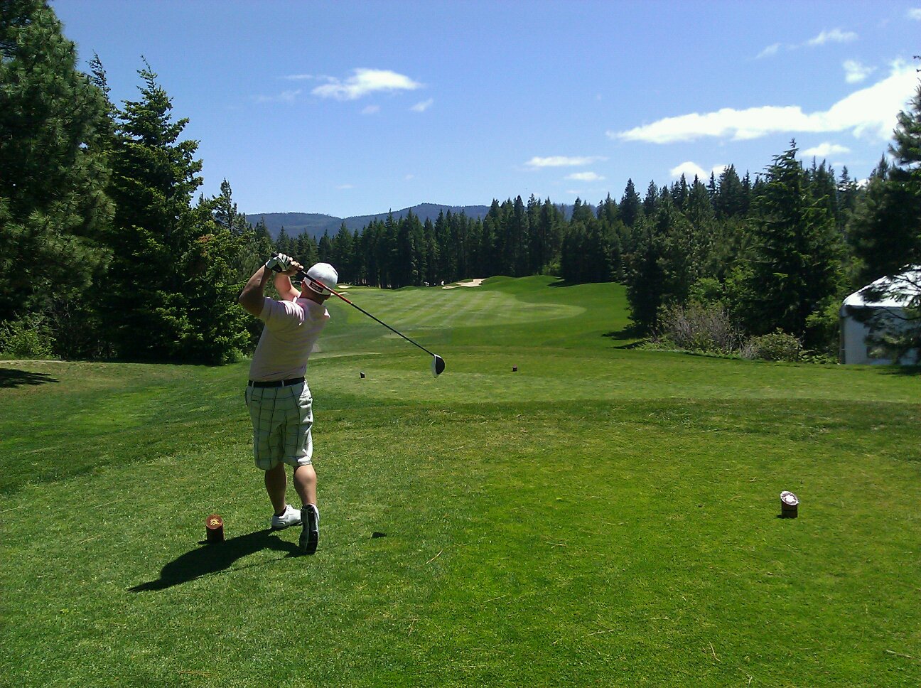 A golfer mid-swing on the tee.