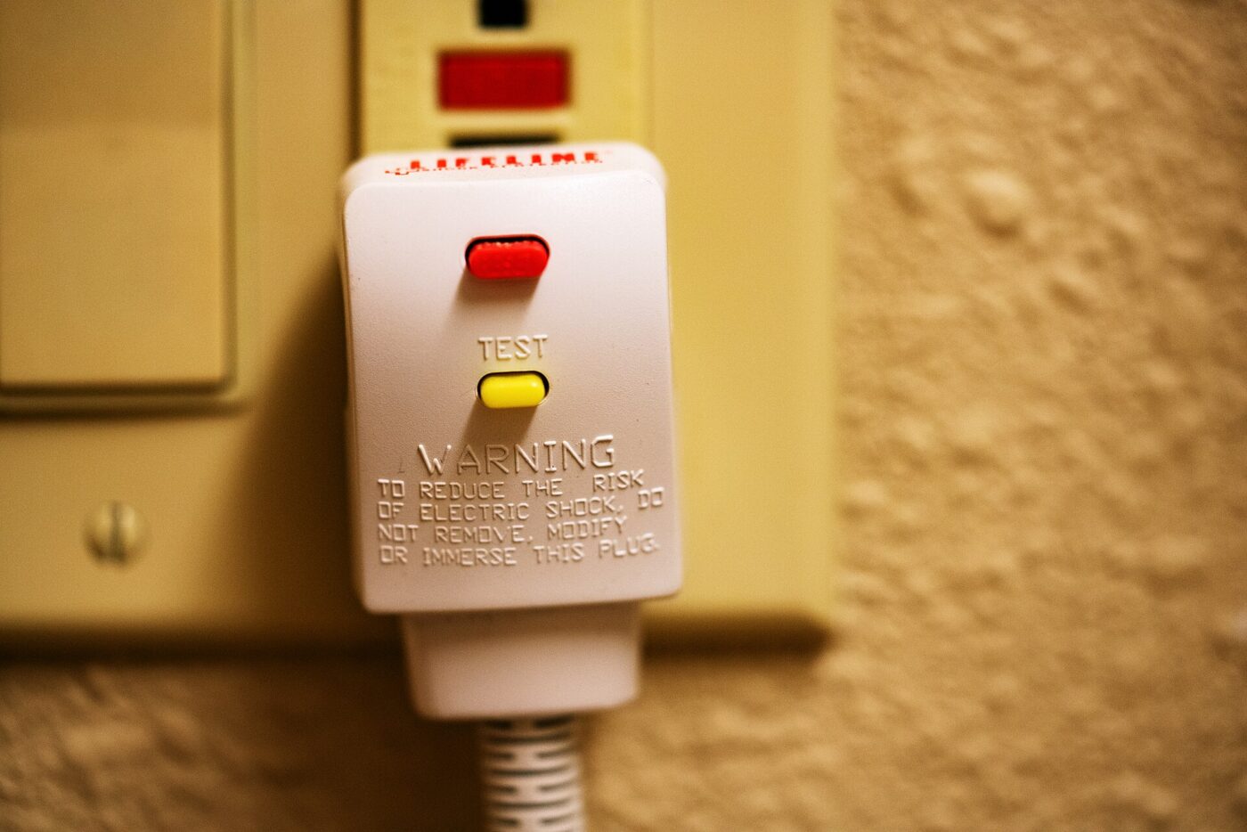 A hair dryer plug with a built-in shock-protection interrupter.