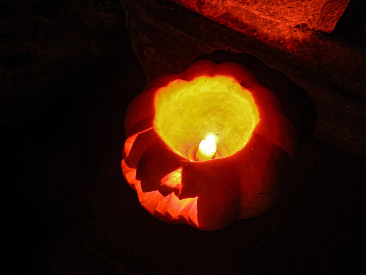 A jack-o’-lantern lit by a candle, the traditional fire hazard.