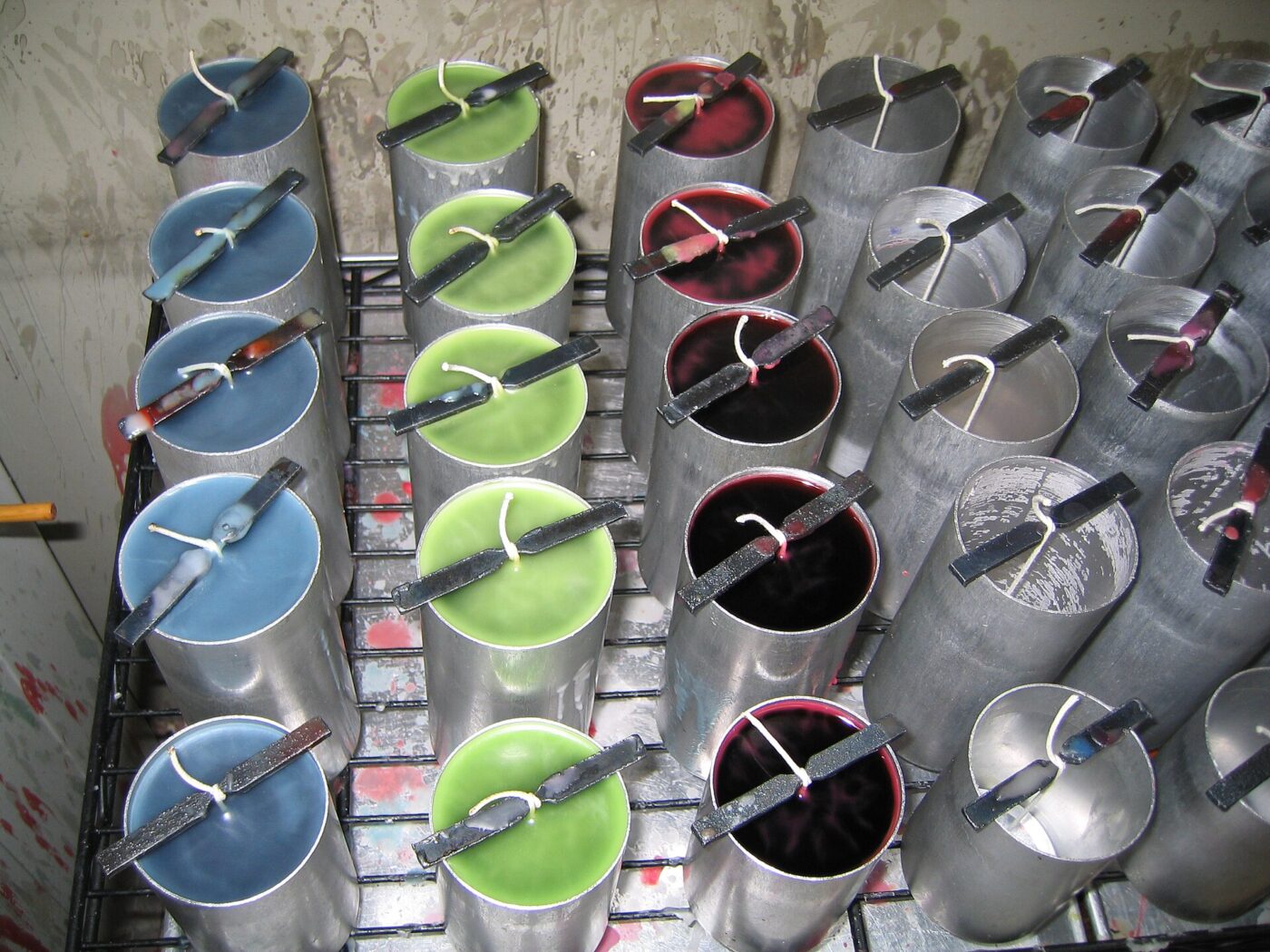 Candles poured into metal moulds at a candle-making workshop.