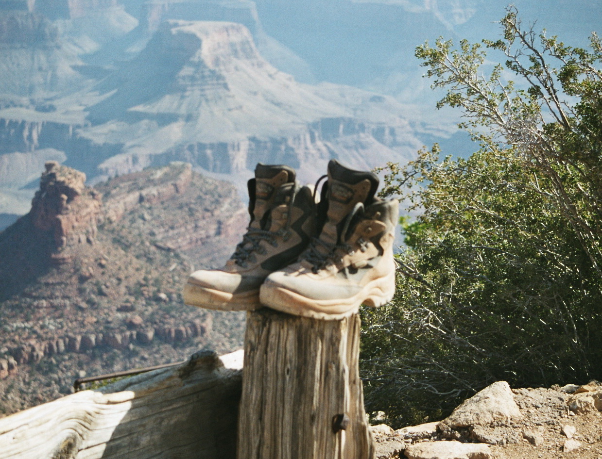Hiking boots drying on a post above the Grand Canyon.