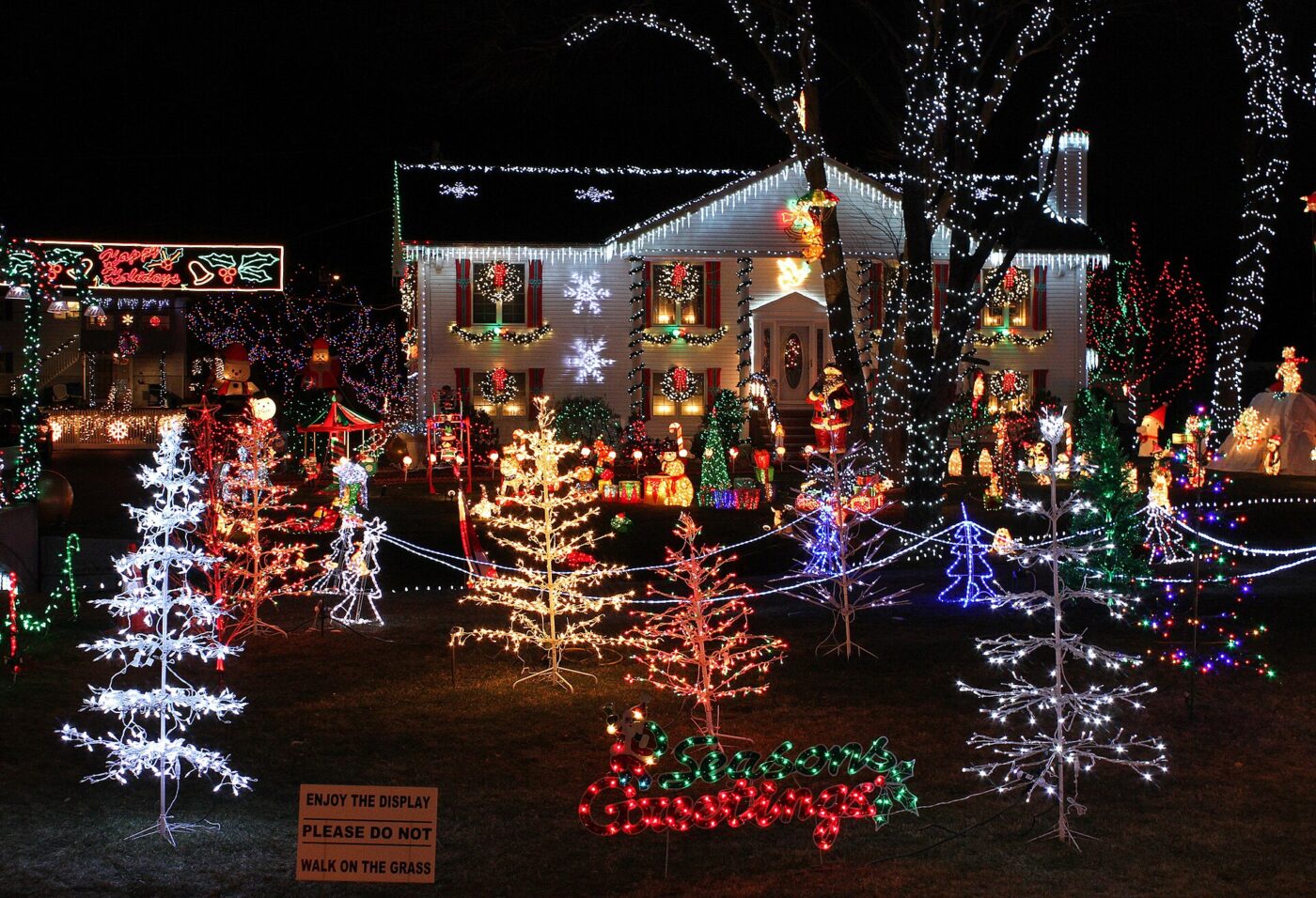 Holiday light displays across a house and yard.