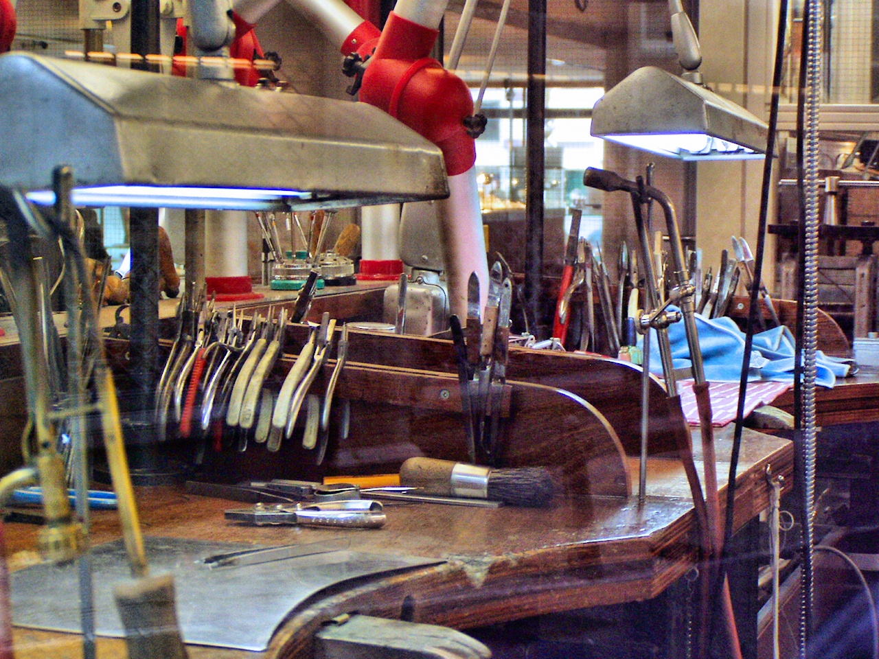 A jeweller’s workbench with hand tools laid out in front of a seat
