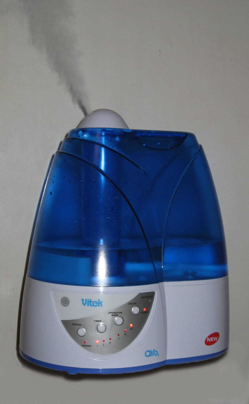 An ultrasonic humidifier with a blue water tank.