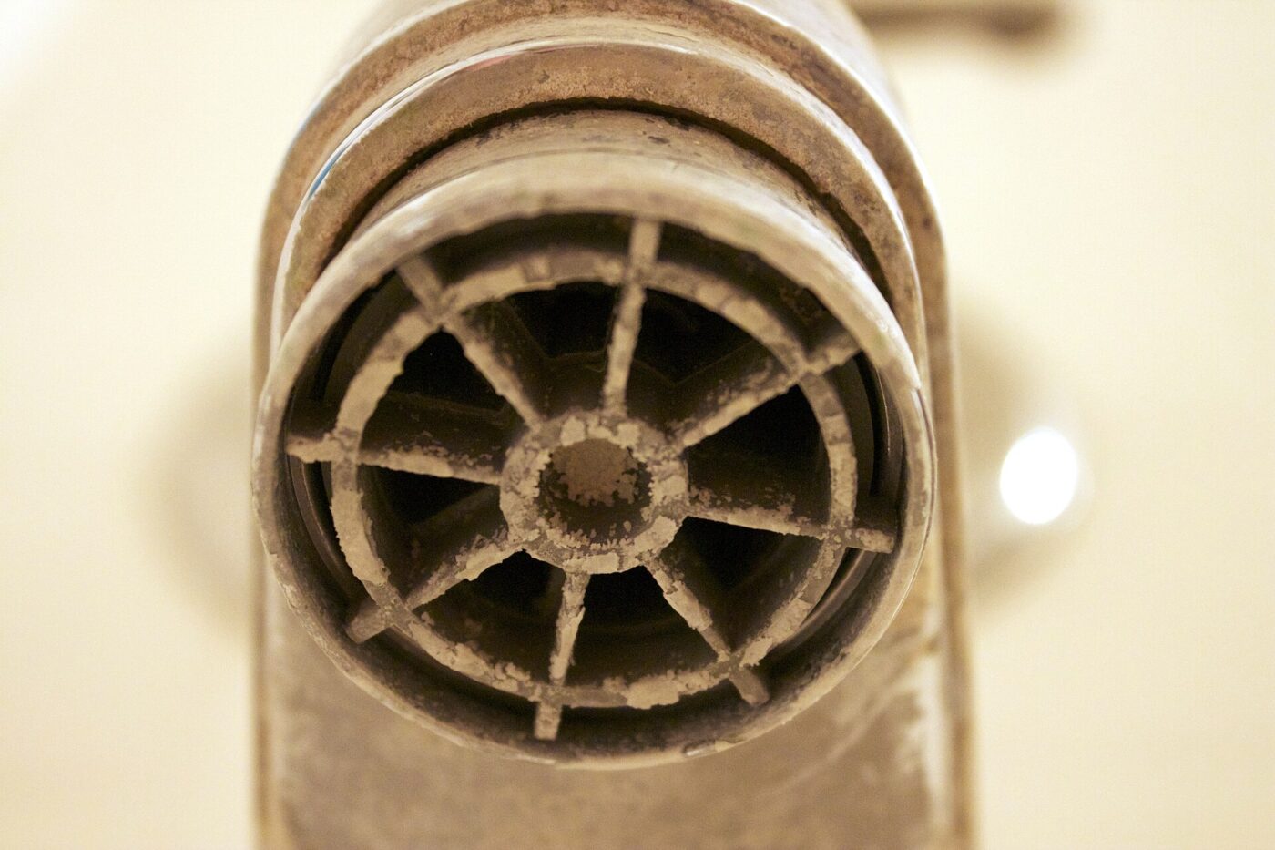 Mineral scale on a tap aerator: the same minerals an ultrasonic humidifier throws into the air as white dust.