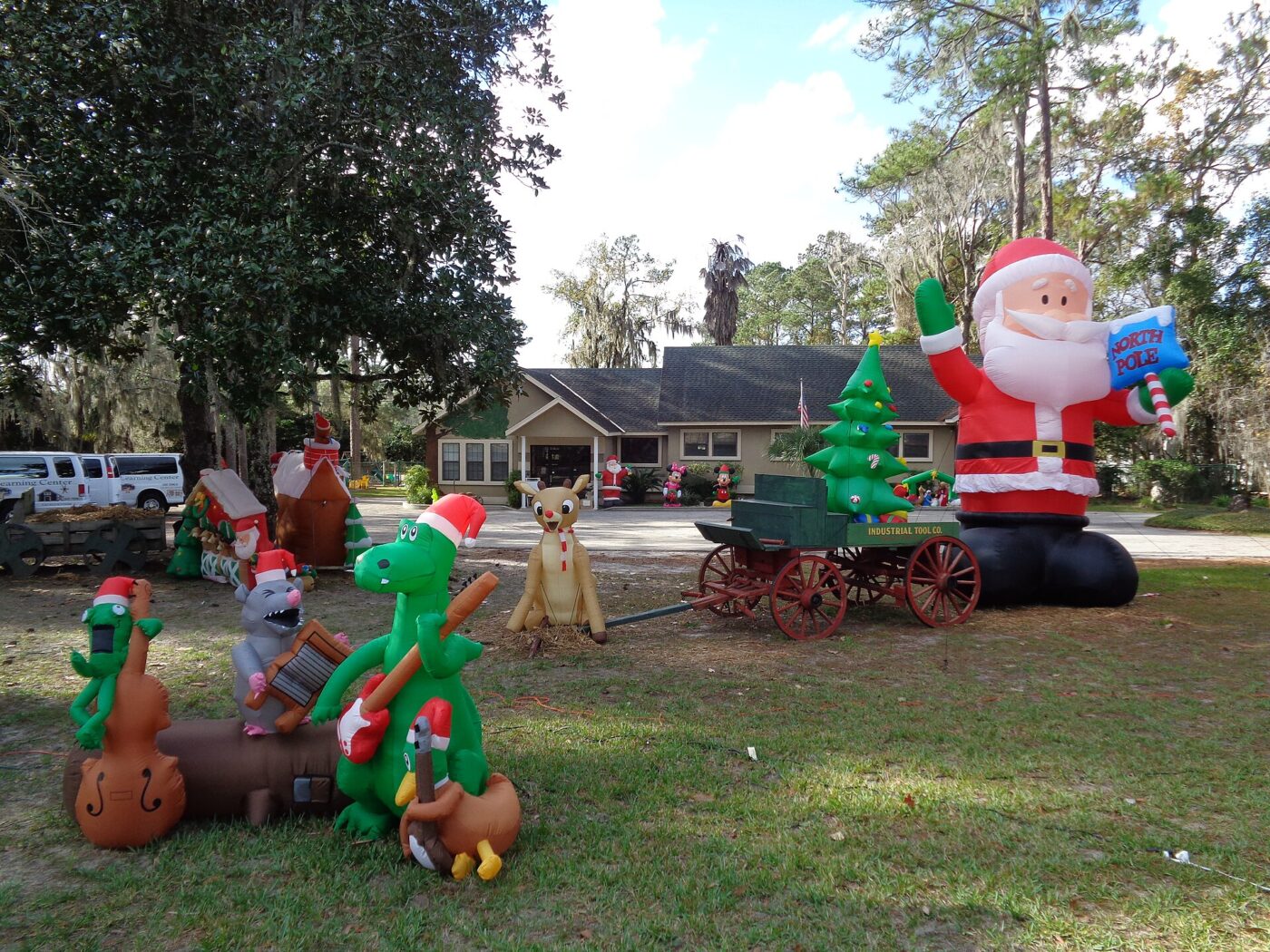 Inflatable holiday decorations on a lawn.