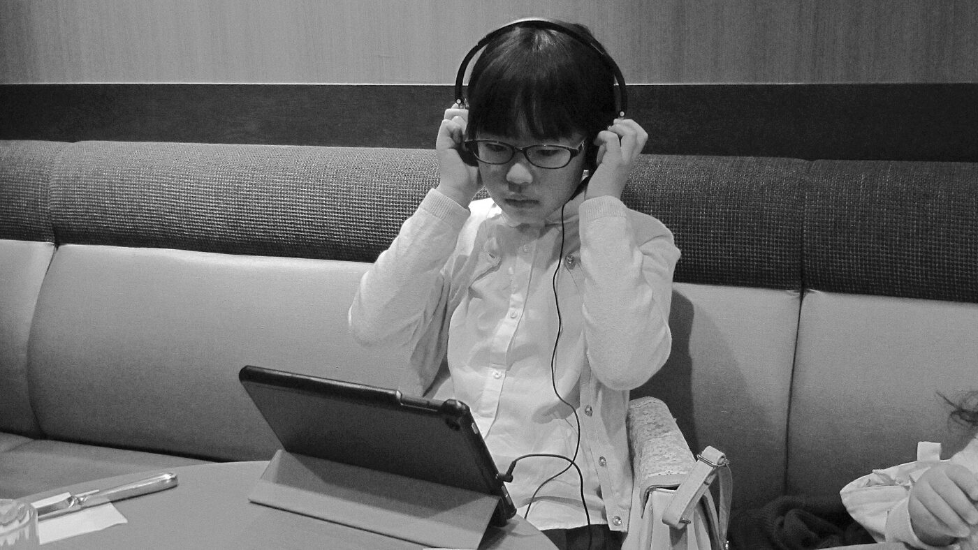 A child listening through headphones.
