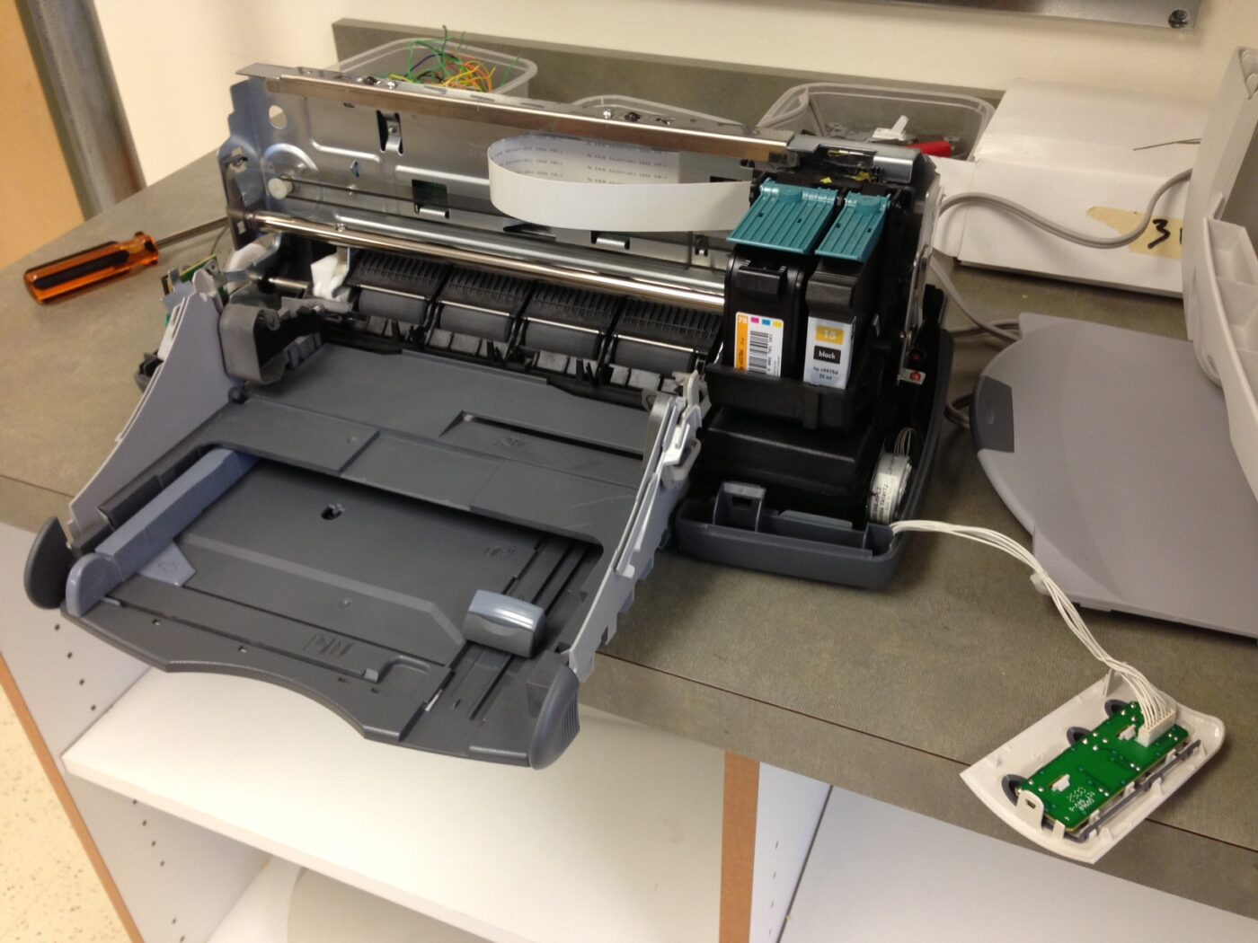 An inkjet printer with its covers removed, showing the print head carriage.