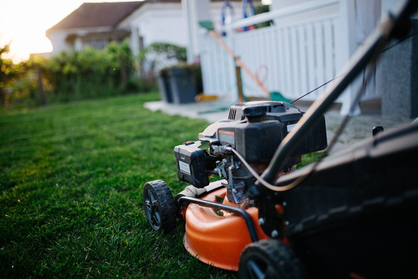 A gas-powered lawn mower on the grass.