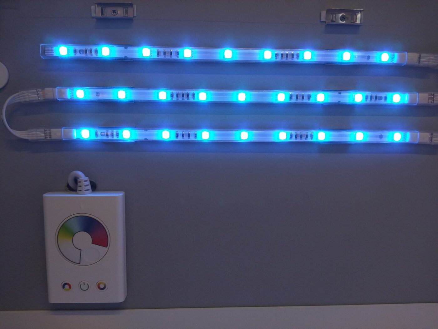 LED strips mounted on a wall with their controller.