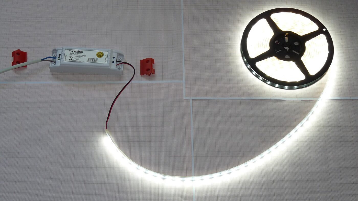 An LED strip light connected to its power supply.