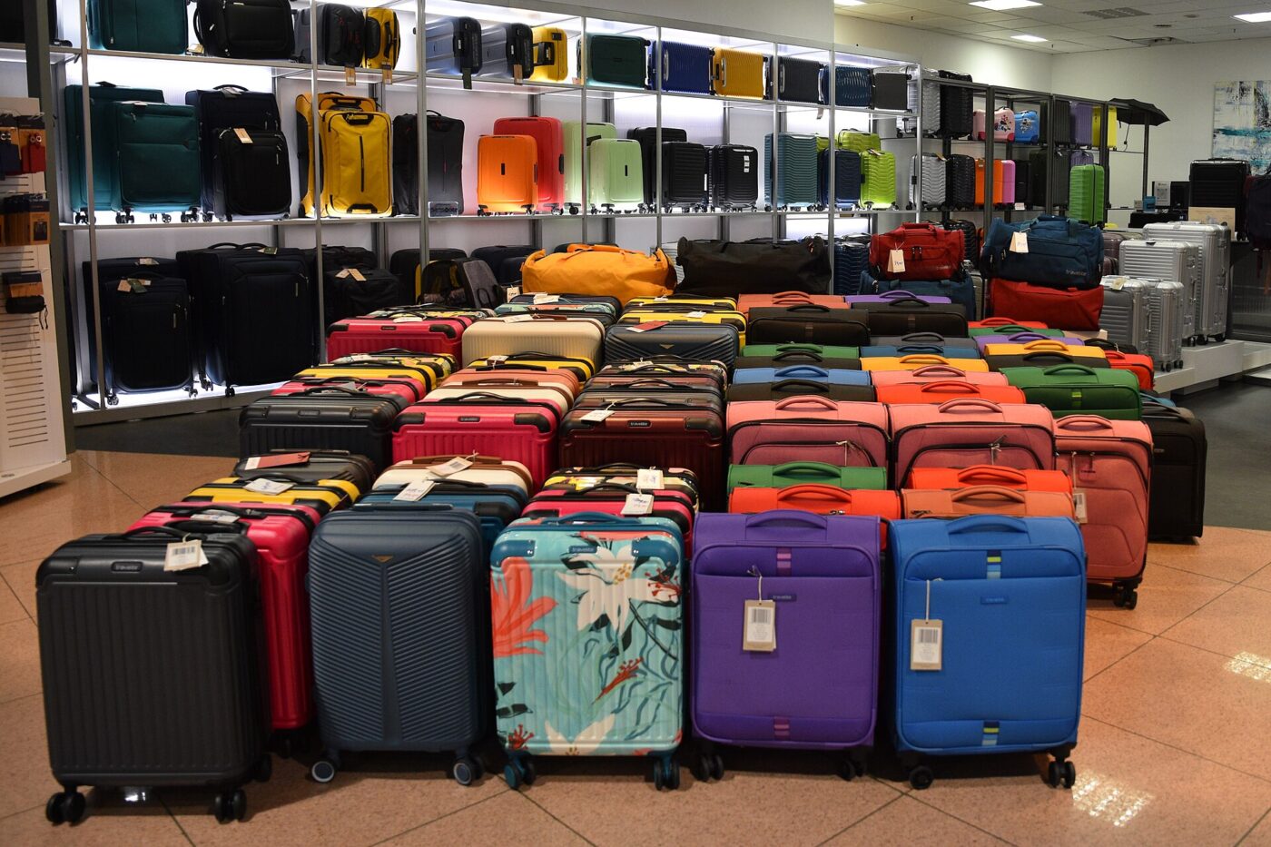 Rows of hard-shell trolley suitcases for sale.