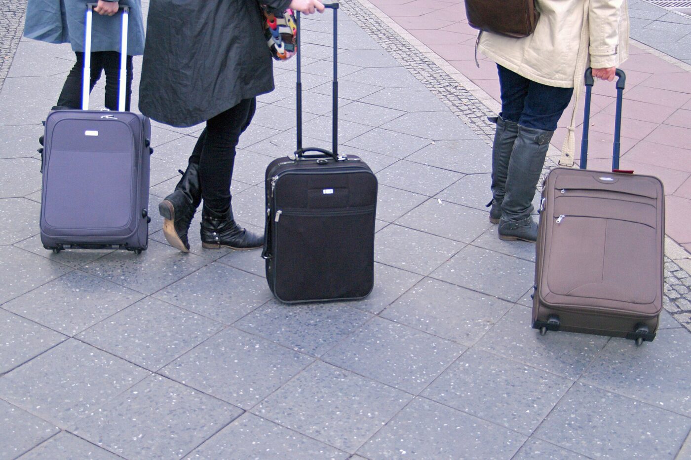Wheeled suitcases rolling along a platform at Berlin Hauptbahnhof.