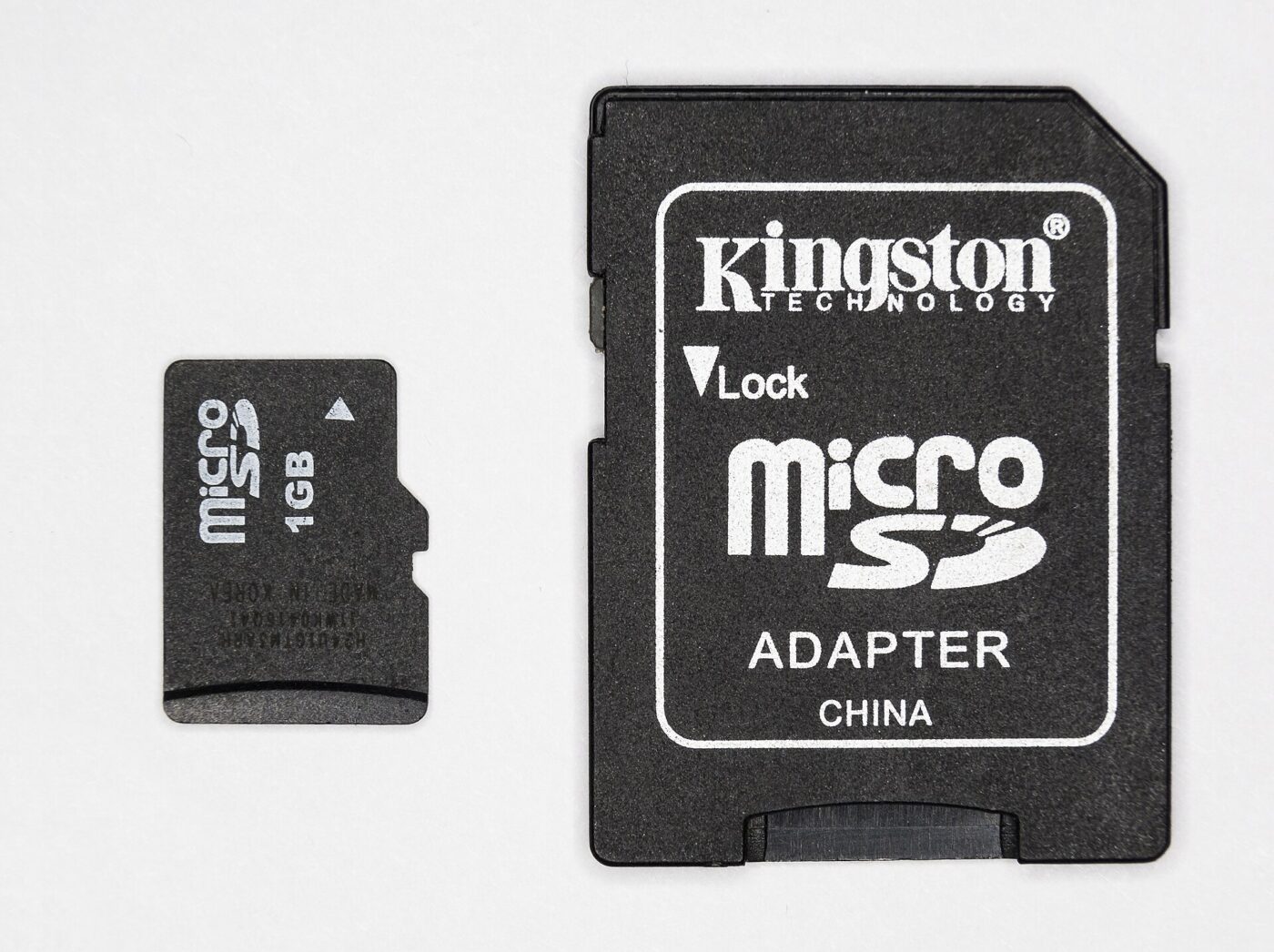 A microSD card with its full-size SD adapter.