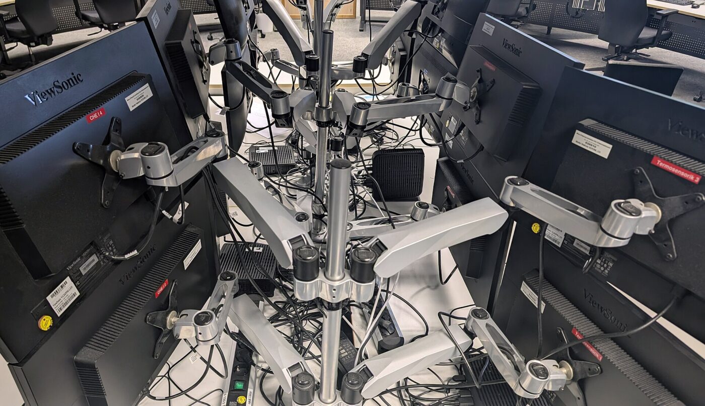 Multi-monitor workstations in the Wendelstein 7-X control room.