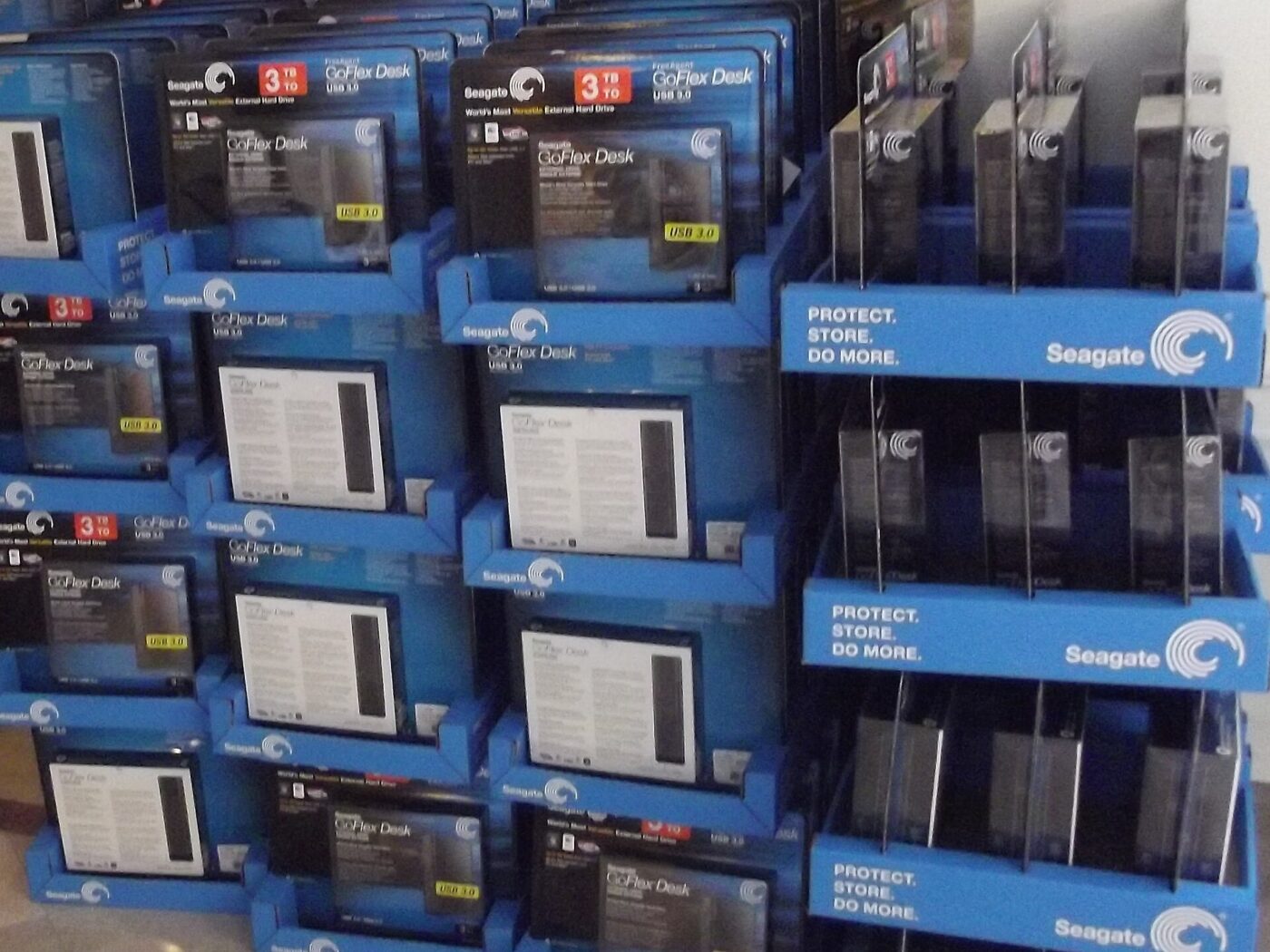 Boxed external hard drives stacked on a retail display.