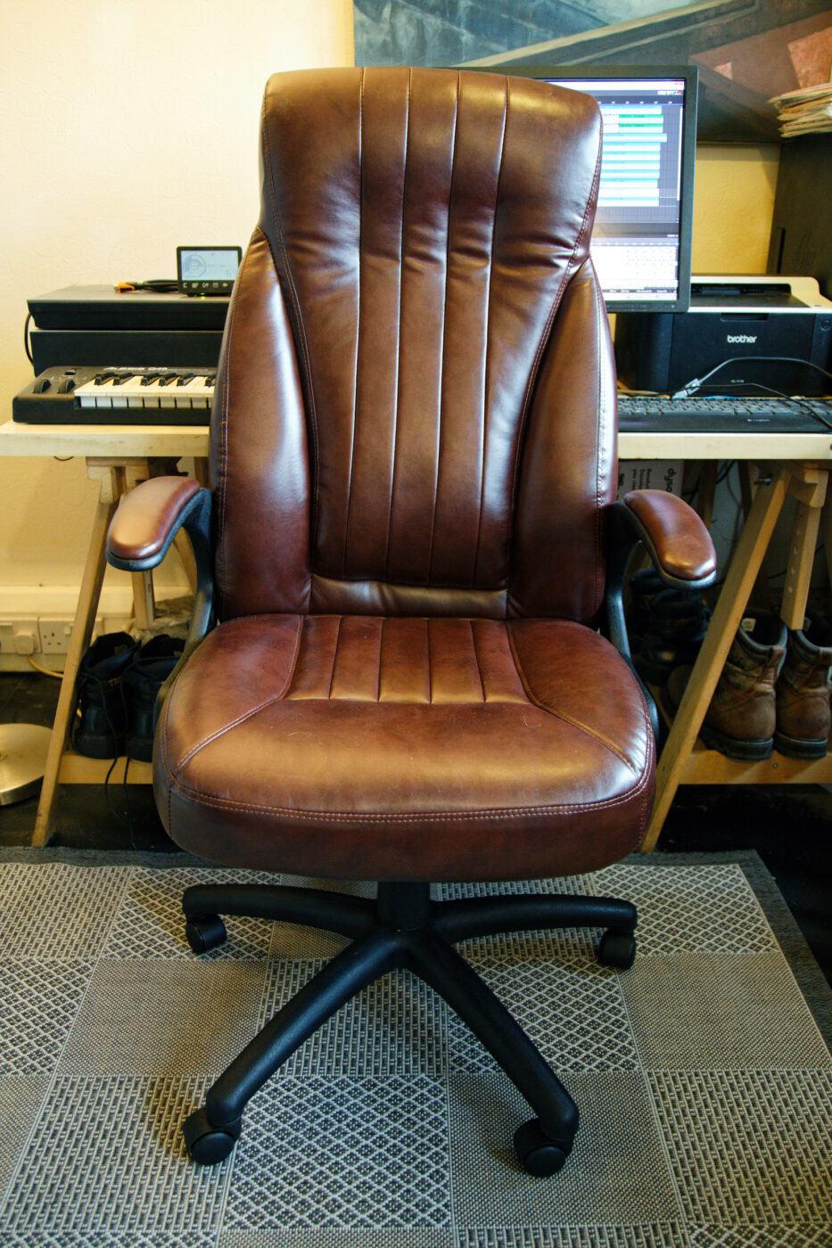 A high-back leather office chair.