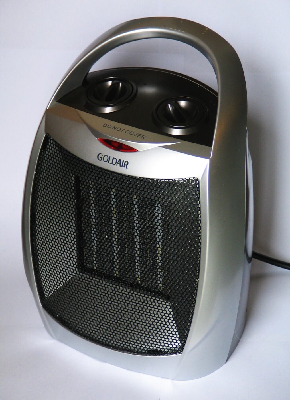 A small black ceramic space heater on a plain background.