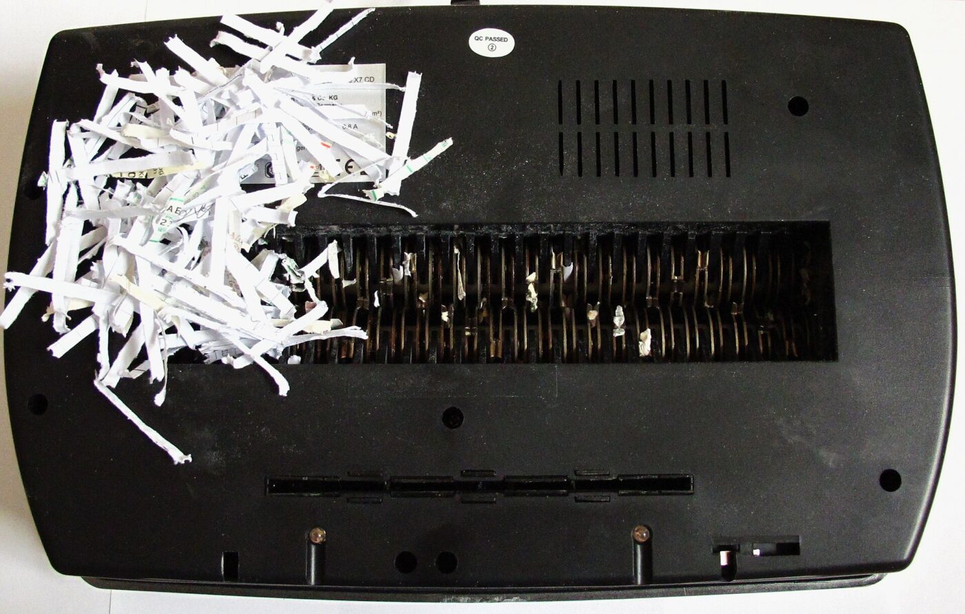 The cutting head of a paper shredder with shredded strips.