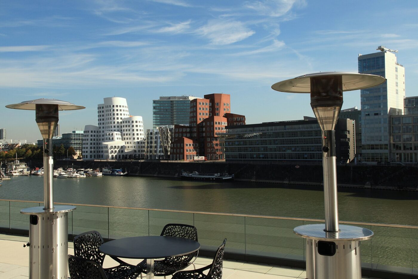 Patio heaters on a riverside café terrace in Düsseldorf.
