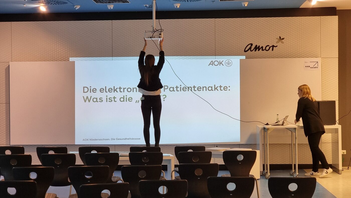 A projected image in a lit presentation room, where ambient light washes out contrast.