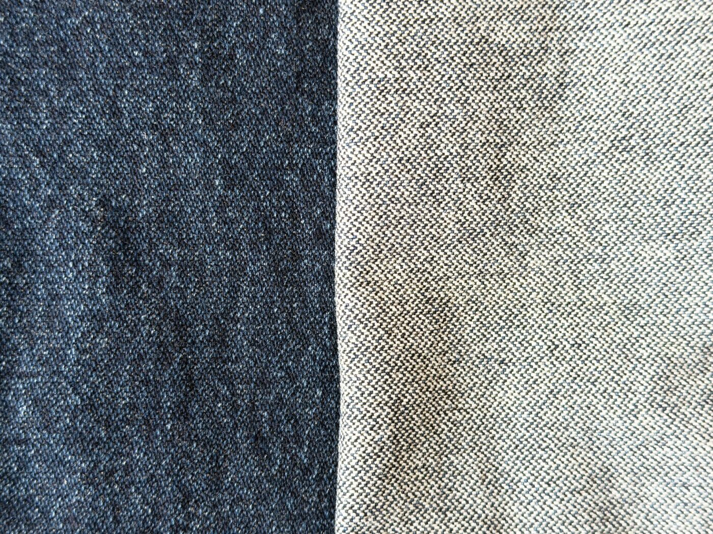 Close-up of denim fabric showing its indigo outer weave next to the lighter inner face.