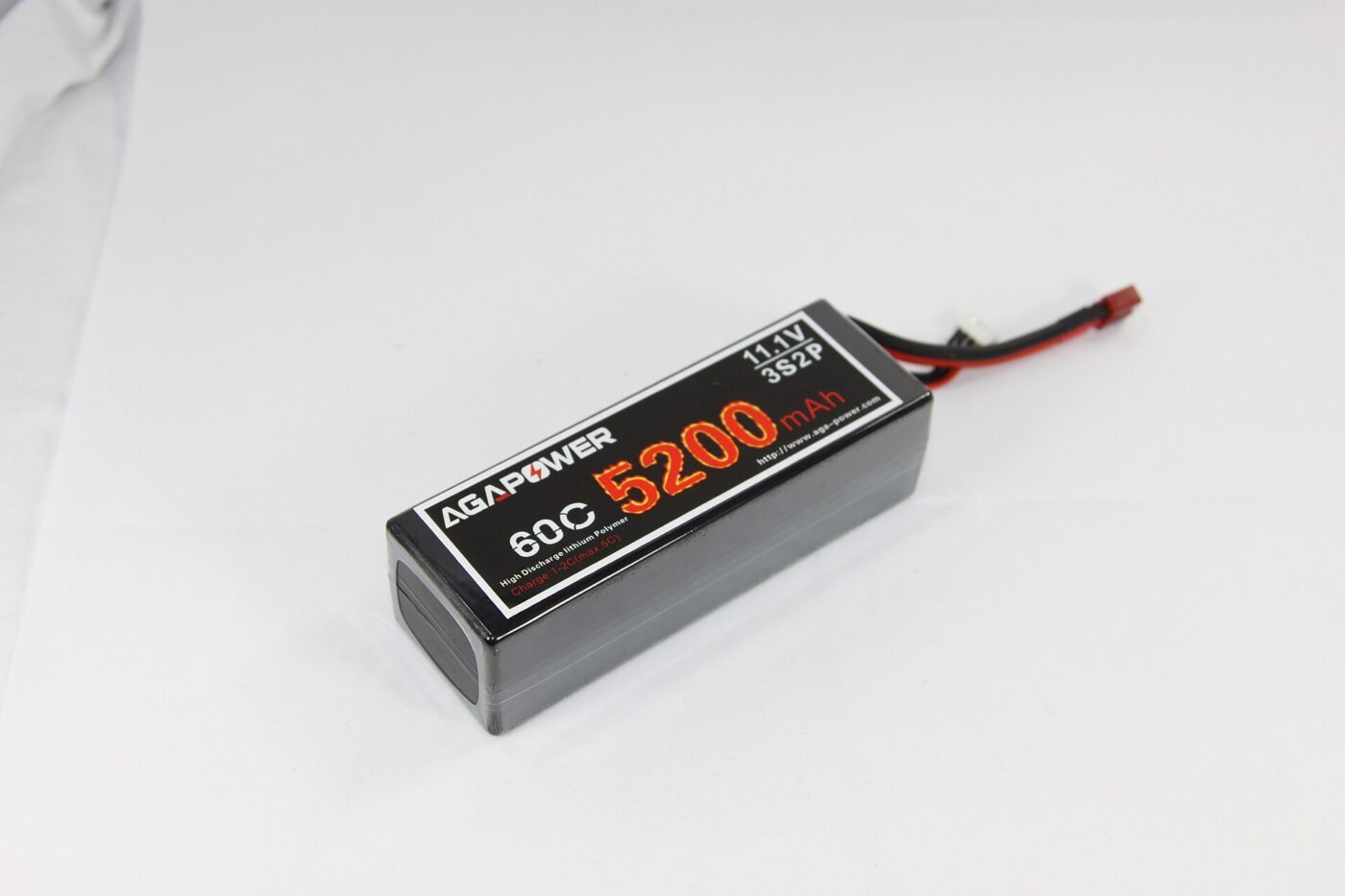A shrink-wrapped lithium polymer RC battery pack with a yellow caution label and connector wires.