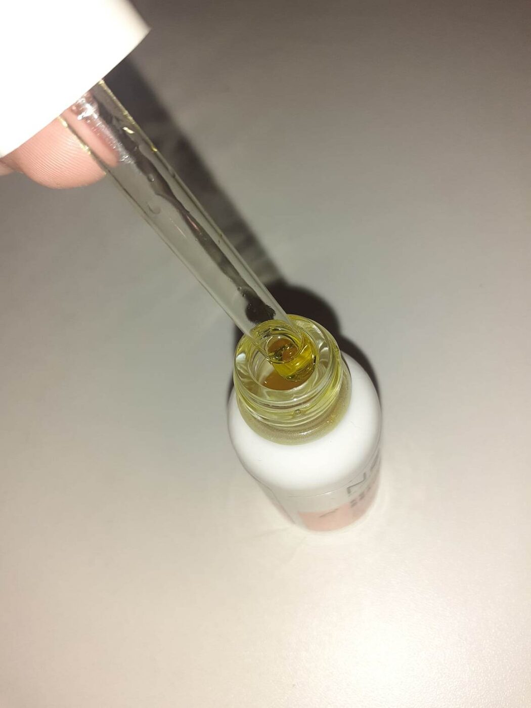 A retinol serum drawn up in a dropper.