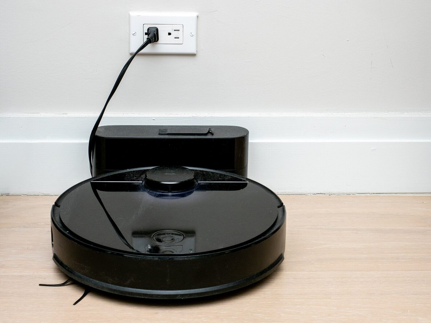 A robot vacuum returning to its charging dock.