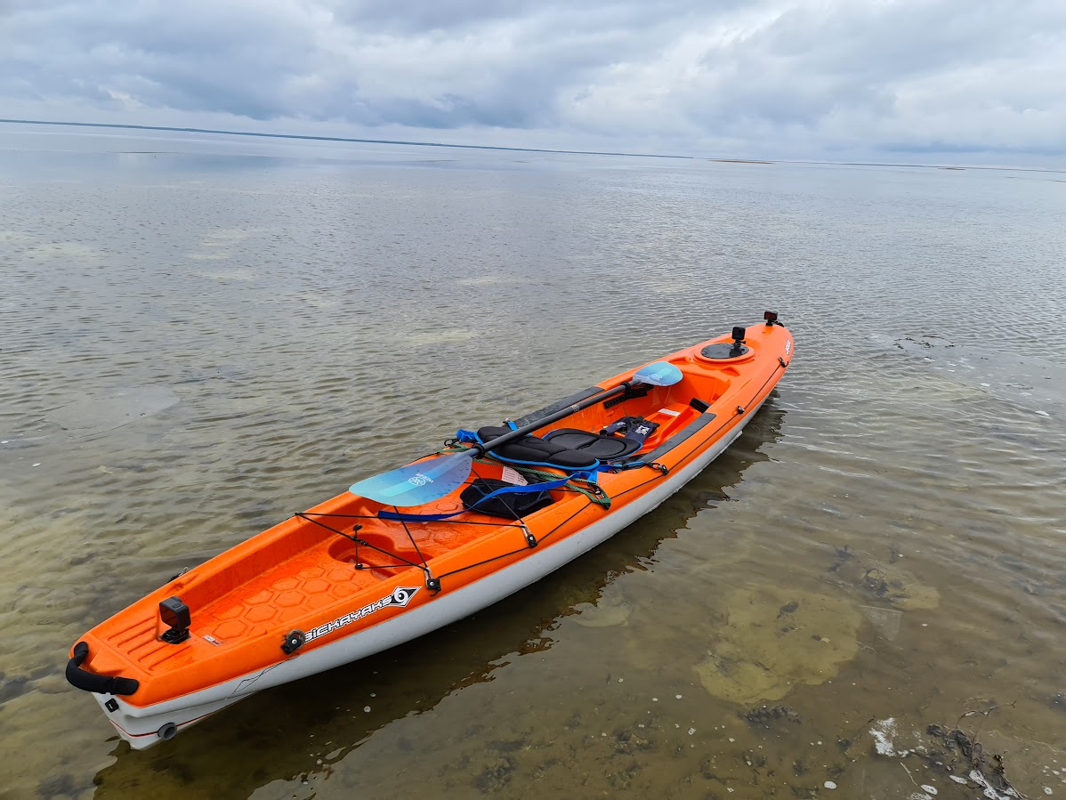 A sit-on-top kayak at the shoreline.