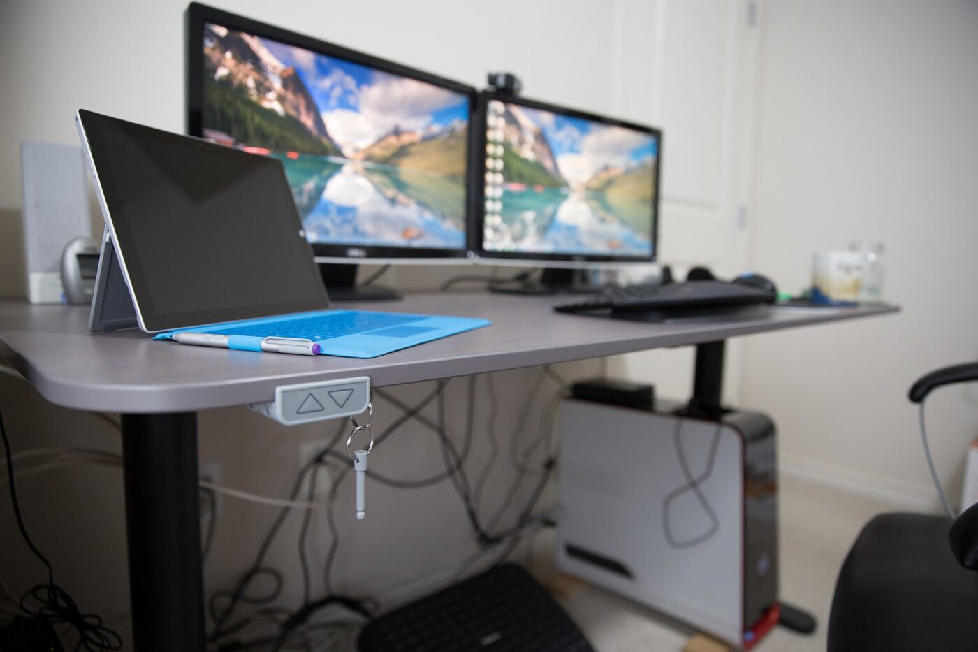 A standing desk's control panel mounted on the underside of the desktop.